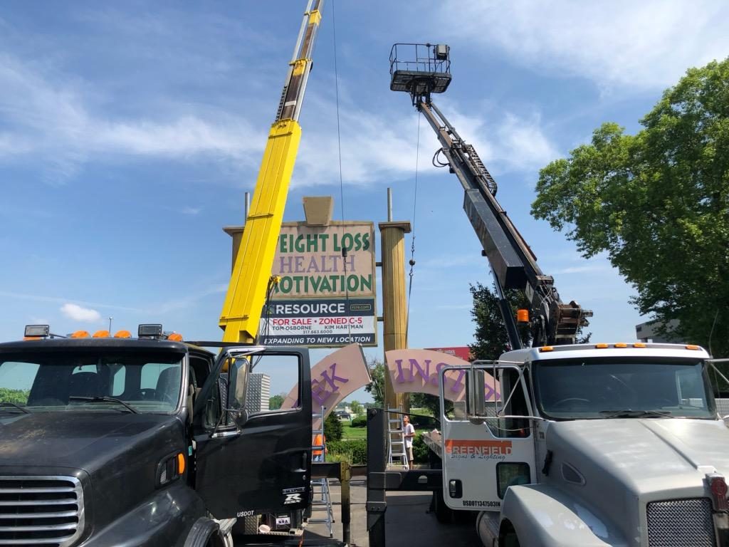 cranes installing pylon sign Indianapolis